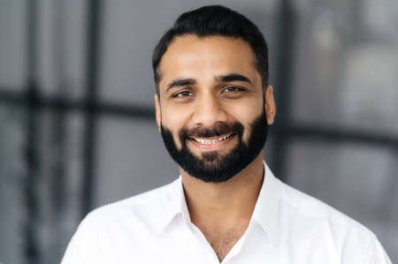 177449938 close up portrait of a successful intelligent bearded indian businessman manager or it specialist