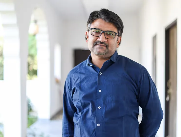 portrait middle aged indian male with eyeglasses wearing blue shirt 665346 27100